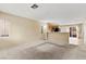 Spacious living room with carpet, a fireplace and seamless flow to the adjacent kitchen at 3619 Hat Rock Ct, Las Vegas, NV 89129