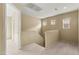 Upstairs loft area with neutral carpeting and multiple windows for natural light at 3619 Hat Rock Ct, Las Vegas, NV 89129