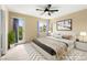 Serene main bedroom with a ceiling fan, plush carpeting, and a private outdoor balcony at 3619 Hat Rock Ct, Las Vegas, NV 89129