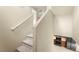 Carpeted staircase leading to a kitchen with modern appliances and ample cabinet space at 3619 Hat Rock Ct, Las Vegas, NV 89129