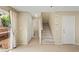 A carpeted staircase between two entryways leads to the upper level, accessible from kitchen at 3619 Hat Rock Ct, Las Vegas, NV 89129