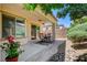 Charming covered patio complemented by lush landscaping, creating a serene outdoor space at 3712 Rocklin Peak Ave, North Las Vegas, NV 89081