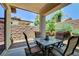 Relaxing covered back patio features an outdoor dining set and beautiful backyard scenery at 3712 Rocklin Peak Ave, North Las Vegas, NV 89081