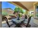 Covered back patio with an outdoor dining set, perfect for relaxing and entertaining guests at 3712 Rocklin Peak Ave, North Las Vegas, NV 89081