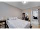 Comfortable bedroom with light walls, soft bedding, and view of the living room at 3712 Rocklin Peak Ave, North Las Vegas, NV 89081