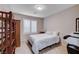 Bedroom with ceiling fan, tiled floor, plantation shutters, and wooden shelving at 3712 Rocklin Peak Ave, North Las Vegas, NV 89081