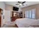 Cozy bedroom featuring a ceiling fan, TV, and plantation shutters for enhanced privacy at 3712 Rocklin Peak Ave, North Las Vegas, NV 89081