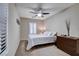 Well-lit bedroom featuring plantation shutters, ceiling fan, and a neutral color palette for relaxation at 3712 Rocklin Peak Ave, North Las Vegas, NV 89081