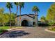Clubhouse entrance with arched entryway, palm trees, and well-maintained landscaping at 3712 Rocklin Peak Ave, North Las Vegas, NV 89081