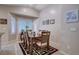 Cozy dining area with a wood table, seating for six, and plantation shutters for natural light at 3712 Rocklin Peak Ave, North Las Vegas, NV 89081