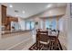 Bright dining area with modern table, slider, and stainless steel appliances in kitchen at 3712 Rocklin Peak Ave, North Las Vegas, NV 89081