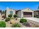 Beautiful desert home with a two-car garage and lush, desert-friendly landscaping at 3712 Rocklin Peak Ave, North Las Vegas, NV 89081