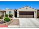 Inviting single-story home with landscaped front yard and brown two-car garage door at 3712 Rocklin Peak Ave, North Las Vegas, NV 89081