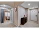 Hallway leading to a bedroom with plantation shutters, natural light, and tiled floor at 3712 Rocklin Peak Ave, North Las Vegas, NV 89081