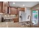 Kitchen featuring granite counters, stainless appliances, tile backsplash, and breakfast bar at 3712 Rocklin Peak Ave, North Las Vegas, NV 89081