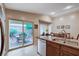 Spacious kitchen flows to backyard patio, features stainless steel appliances, granite counters, and ample storage at 3712 Rocklin Peak Ave, North Las Vegas, NV 89081