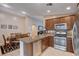 Open kitchen featuring stainless steel appliances, granite countertops, and adjacent dining area at 3712 Rocklin Peak Ave, North Las Vegas, NV 89081