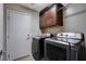 Laundry room with overhead cabinets, and modern side by side washer and dryer at 3712 Rocklin Peak Ave, North Las Vegas, NV 89081