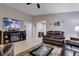 Cozy living room with tile flooring, entertainment center, and comfortable leather seating at 3712 Rocklin Peak Ave, North Las Vegas, NV 89081