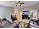 Inviting living room featuring tile flooring, a ceiling fan, and an entertainment center at 3712 Rocklin Peak Ave, North Las Vegas, NV 89081