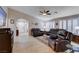 Spacious living room features tile flooring, shutters, ceiling fan and comfortable leather furniture at 3712 Rocklin Peak Ave, North Las Vegas, NV 89081