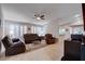 Bright living room with tile floors, ceiling fan and comfortable leather furniture at 3712 Rocklin Peak Ave, North Las Vegas, NV 89081