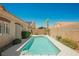 Gorgeous backyard with a sparkling pool, desert landscaping, and mature trees, perfect for relaxation at 3882 Genoa Dr, Las Vegas, NV 89141