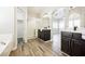 Contemporary bathroom with a glass-enclosed shower, sleek vanity, and stylish wood-look flooring at 3882 Genoa Dr, Las Vegas, NV 89141