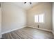 Cozy bedroom featuring wood-look tile, bright windows, and neutral color scheme at 3882 Genoa Dr, Las Vegas, NV 89141
