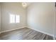 Elegant bedroom with a modern chandelier, plantation shutters, and wood-look flooring at 3882 Genoa Dr, Las Vegas, NV 89141