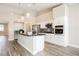 Well-equipped kitchen with stainless steel appliances, white cabinetry, and a breakfast bar at 3882 Genoa Dr, Las Vegas, NV 89141