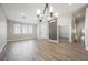 Spacious living room featuring wood-look tile flooring and arched windows for natural light at 3882 Genoa Dr, Las Vegas, NV 89141