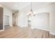 Bright living area with wood-look tile flooring, elegant chandelier, and neutral paint at 3882 Genoa Dr, Las Vegas, NV 89141