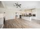 Open-concept kitchen and living space with wood-look tile flooring and a cozy fireplace at 3882 Genoa Dr, Las Vegas, NV 89141
