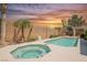 Relaxing backyard featuring a sparkling pool and spa surrounded by desert landscaping at 3882 Genoa Dr, Las Vegas, NV 89141