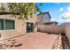 Paver stone backyard with neutral stucco home, privacy fence and small tree at 4321 Stockbridge St, Las Vegas, NV 89115