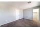 Spacious bedroom with neutral-colored walls, plush carpet and access to an open closet at 4321 Stockbridge St, Las Vegas, NV 89115
