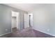 An open, airy bedroom featuring neutral gray walls, carpet flooring and two accessible entryways at 4321 Stockbridge St, Las Vegas, NV 89115