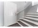 Inviting entryway features the front door, luxury vinyl plank flooring, and stairs with a modern handrail at 4321 Stockbridge St, Las Vegas, NV 89115