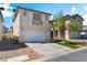 Front exterior showcasing neutral stucco, a two-car garage, small front lawn, and easy street access at 4321 Stockbridge St, Las Vegas, NV 89115
