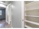 Hallway featuring wood-style floors, and a bright white open shelving closet at 4321 Stockbridge St, Las Vegas, NV 89115
