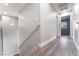 Upstairs hallway with wood-style flooring and gray walls leading to bedrooms at 4321 Stockbridge St, Las Vegas, NV 89115