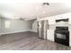 Open-concept living room and kitchen with stainless steel appliances and wood-look floors at 4321 Stockbridge St, Las Vegas, NV 89115