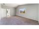 Bright main bedroom with carpet, large window, and ensuite bathroom access at 4321 Stockbridge St, Las Vegas, NV 89115