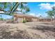 Expansive backyard featuring desert landscaping, mature trees, and a covered patio at 439 Pelican Bay Ct, Henderson, NV 89012