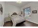 Cozy bedroom featuring a comfortable bed, wood floors, and a bright window at 439 Pelican Bay Ct, Henderson, NV 89012