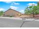 Street view of home exterior with desert landscaping, mature trees and privacy fence at 439 Pelican Bay Ct, Henderson, NV 89012