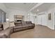 Bright living room with wood flooring and a comfortable brown leather sectional sofa at 439 Pelican Bay Ct, Henderson, NV 89012
