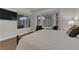 Bright main bedroom with large windows, hardwood floors, and a TV at 439 Pelican Bay Ct, Henderson, NV 89012