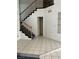 Entryway featuring light tile flooring and a staircase leading to the second level at 5024 Saint Annes Dr, Las Vegas, NV 89149